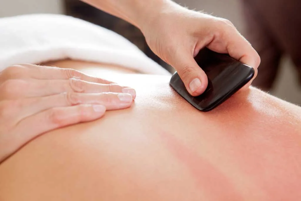 Gua sha — a smooth scraping tool worked across the back
